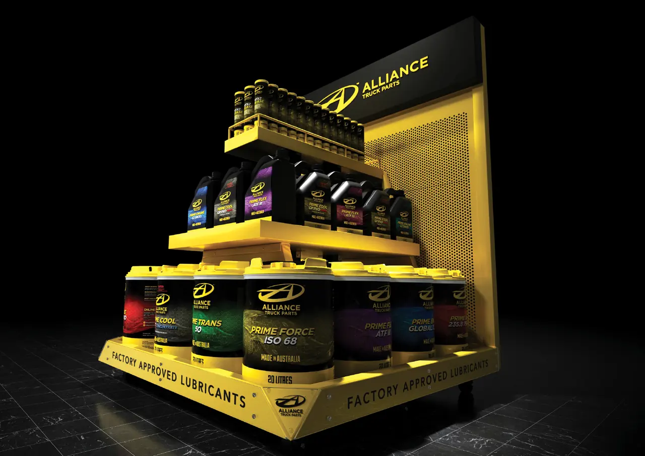 Yellow Alliance Truck Parts retail display stand stocked with branded lubricant bottles and 20 litre drums