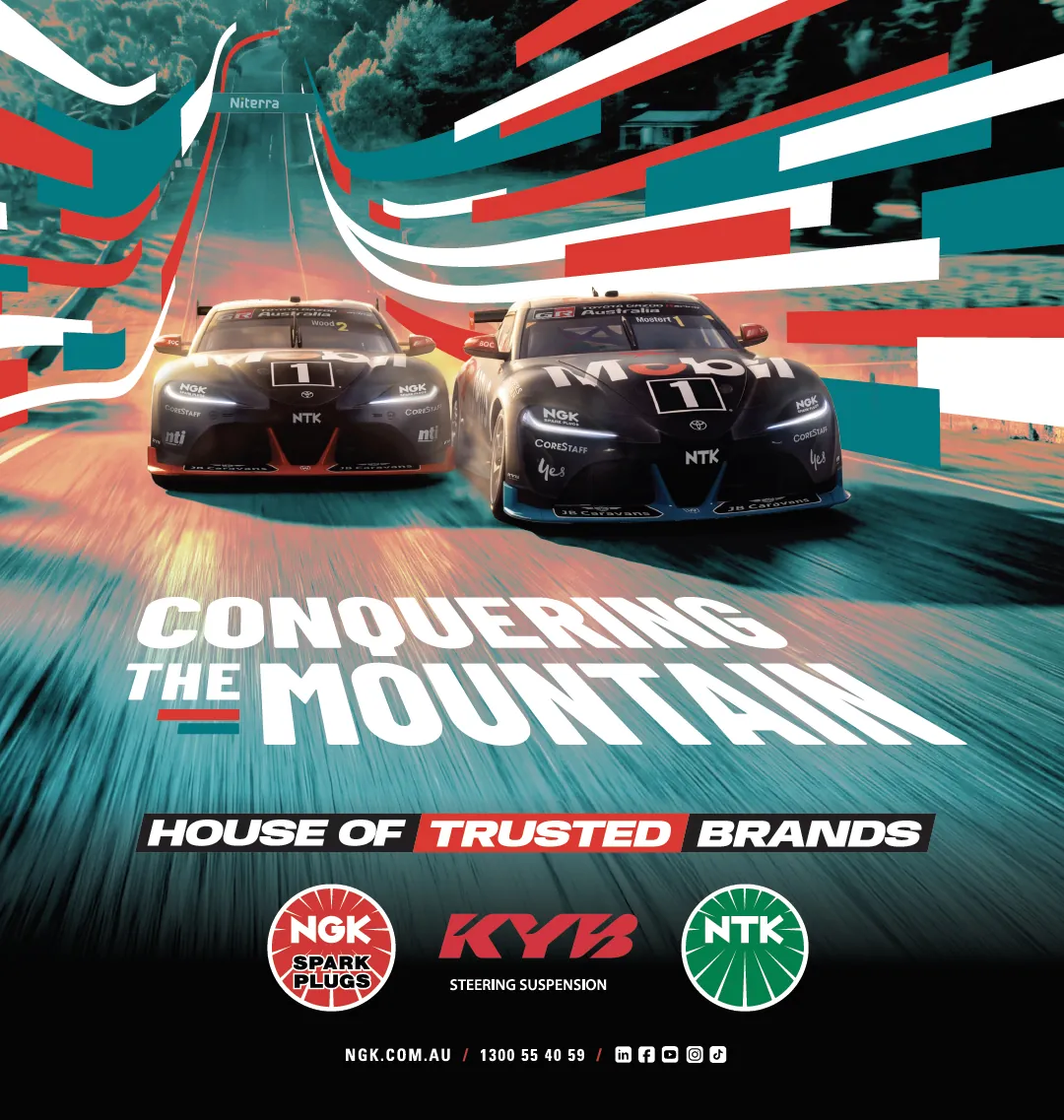 NGK, KYB and NTK Conquering the Mountain print ad with two Supercars racing uphill, House of Trusted Brands