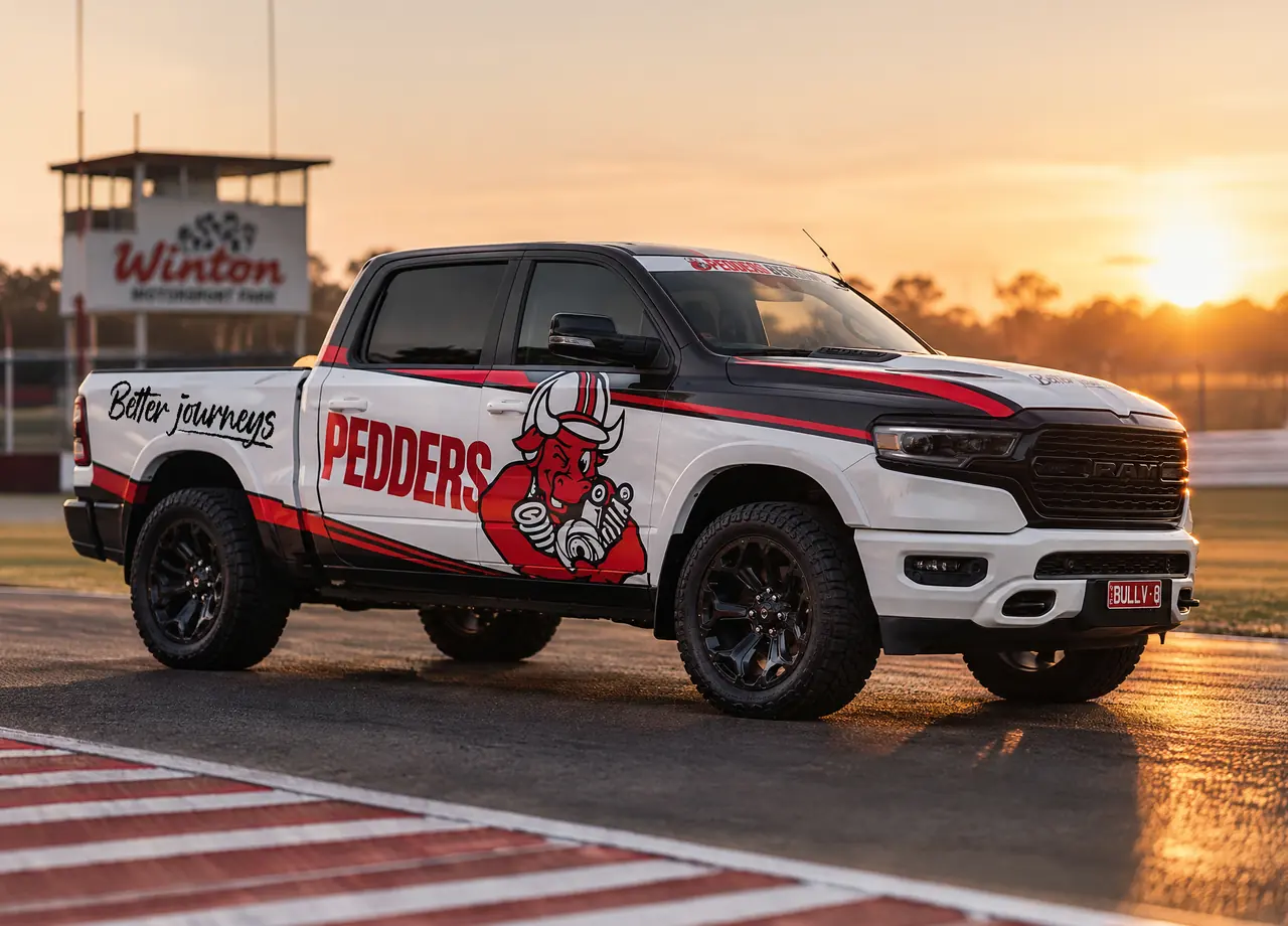 Signwritten ute at a racetrack at sunset